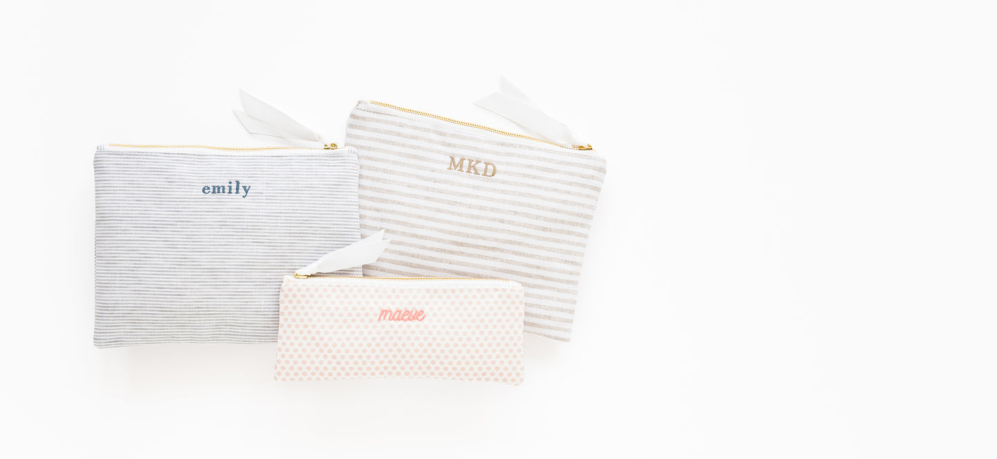 Fabric pouches with names 'emily' and 'MKD' and 
