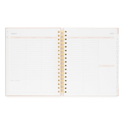 Open spiral bound planner with weekly layout and space for today's priority in the bottom of each day of the week