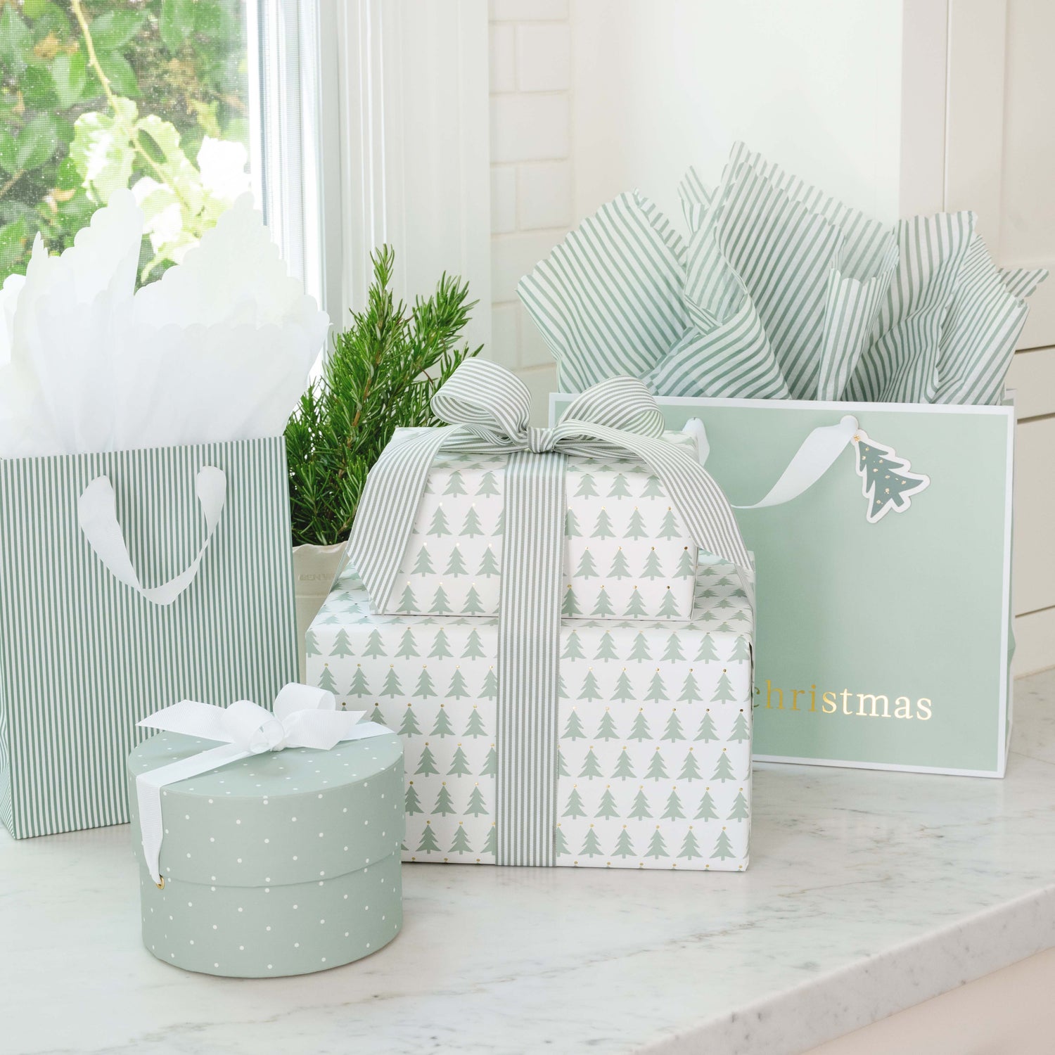Set of gift boxes with festive designs on a light surface.