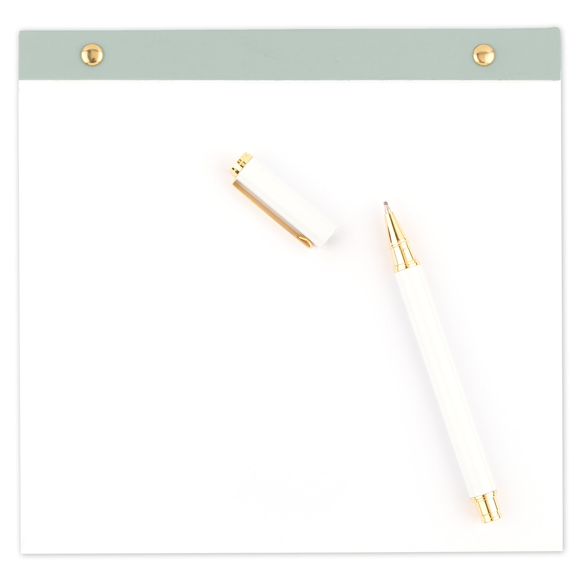 note pad set stacked with white pen with gold details