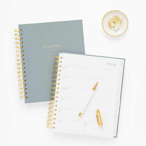 blue spiral 2025-2026 academic planner showing planner closed and planner open to weekly page in august 2025