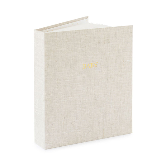 flax fabric baby book book open standing up foil stamped with baby in gold on the cover
