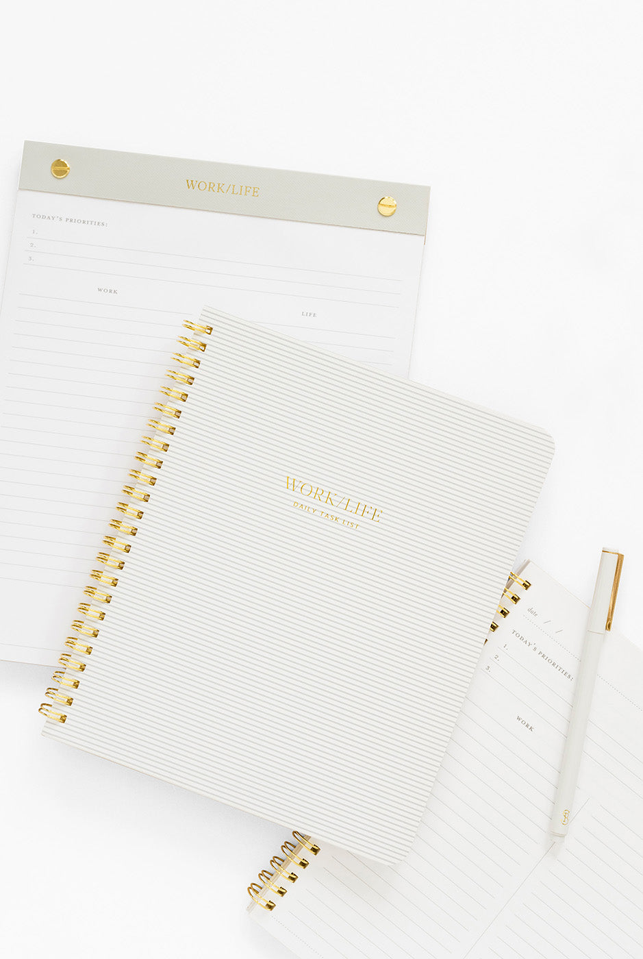 Pale grey notebook and notepad with "work/life" printed on them.