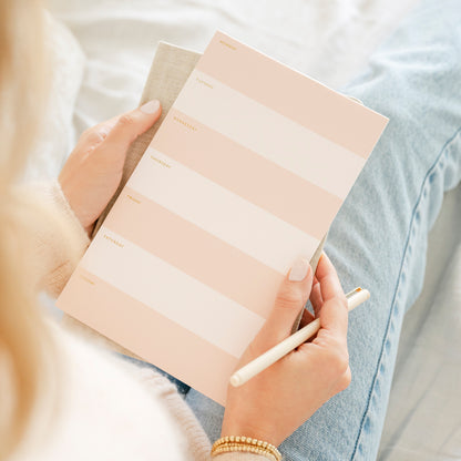 Pink and white striped weekly notepad