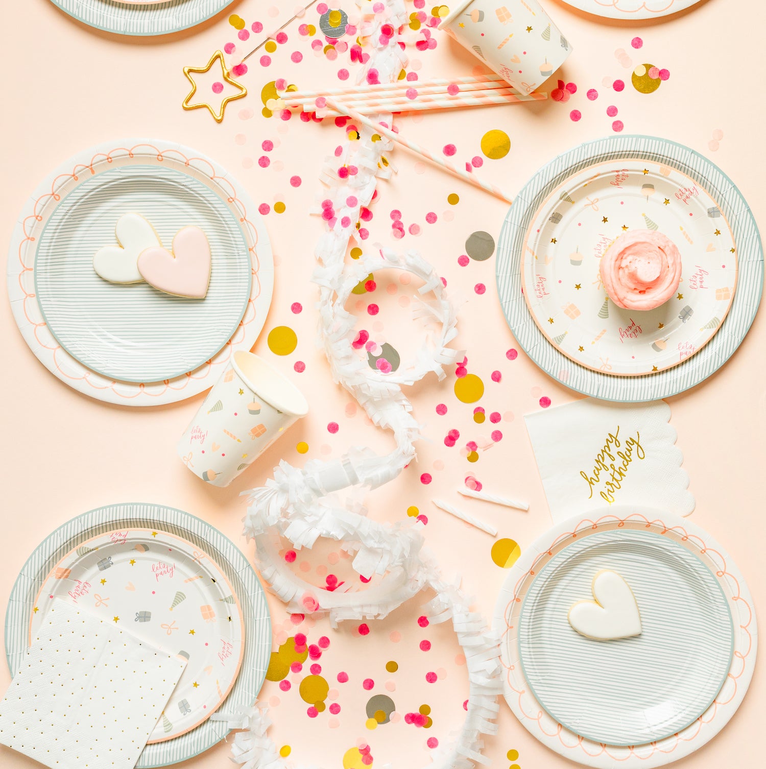 Birthday party tablescape with pink blue gold and white pattern designs