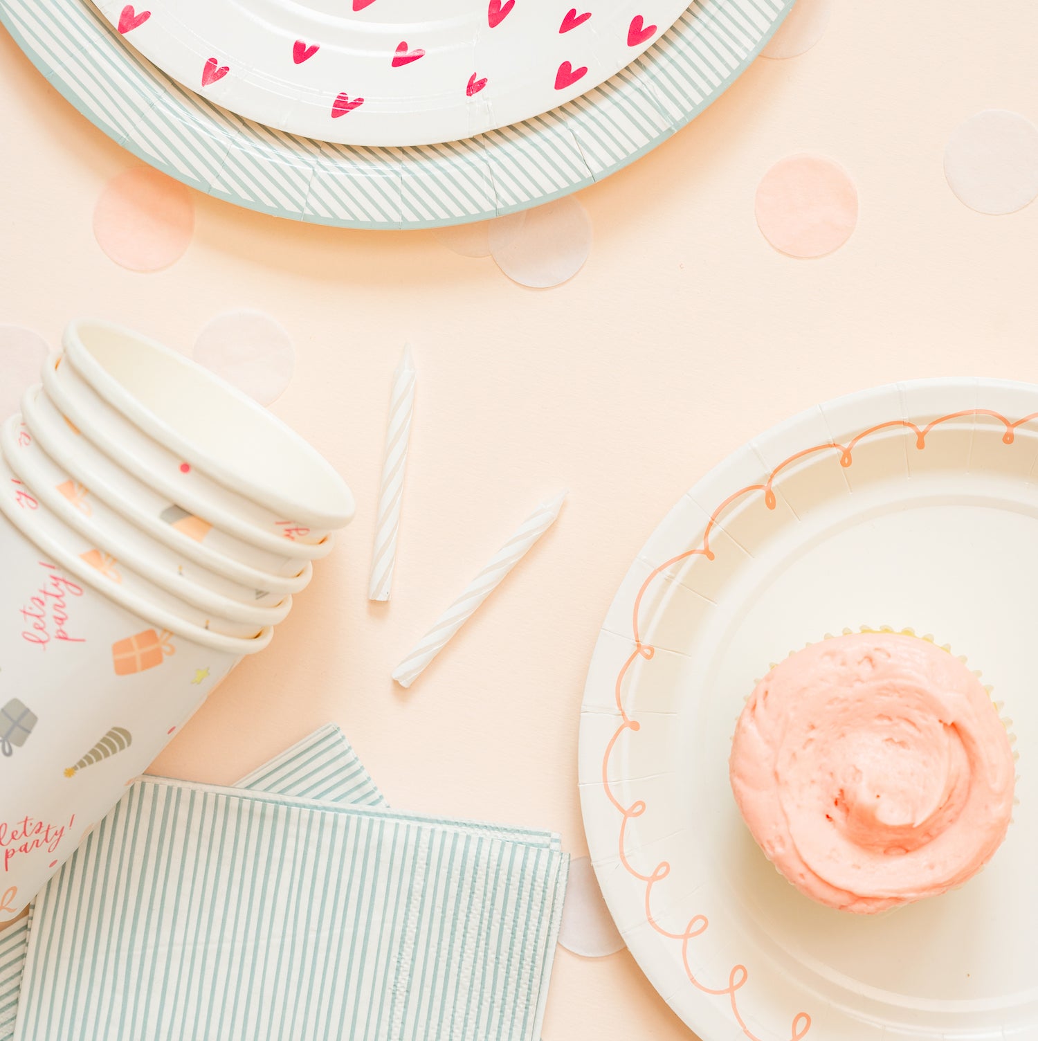 stack of birthday party cups on party table with cupcake