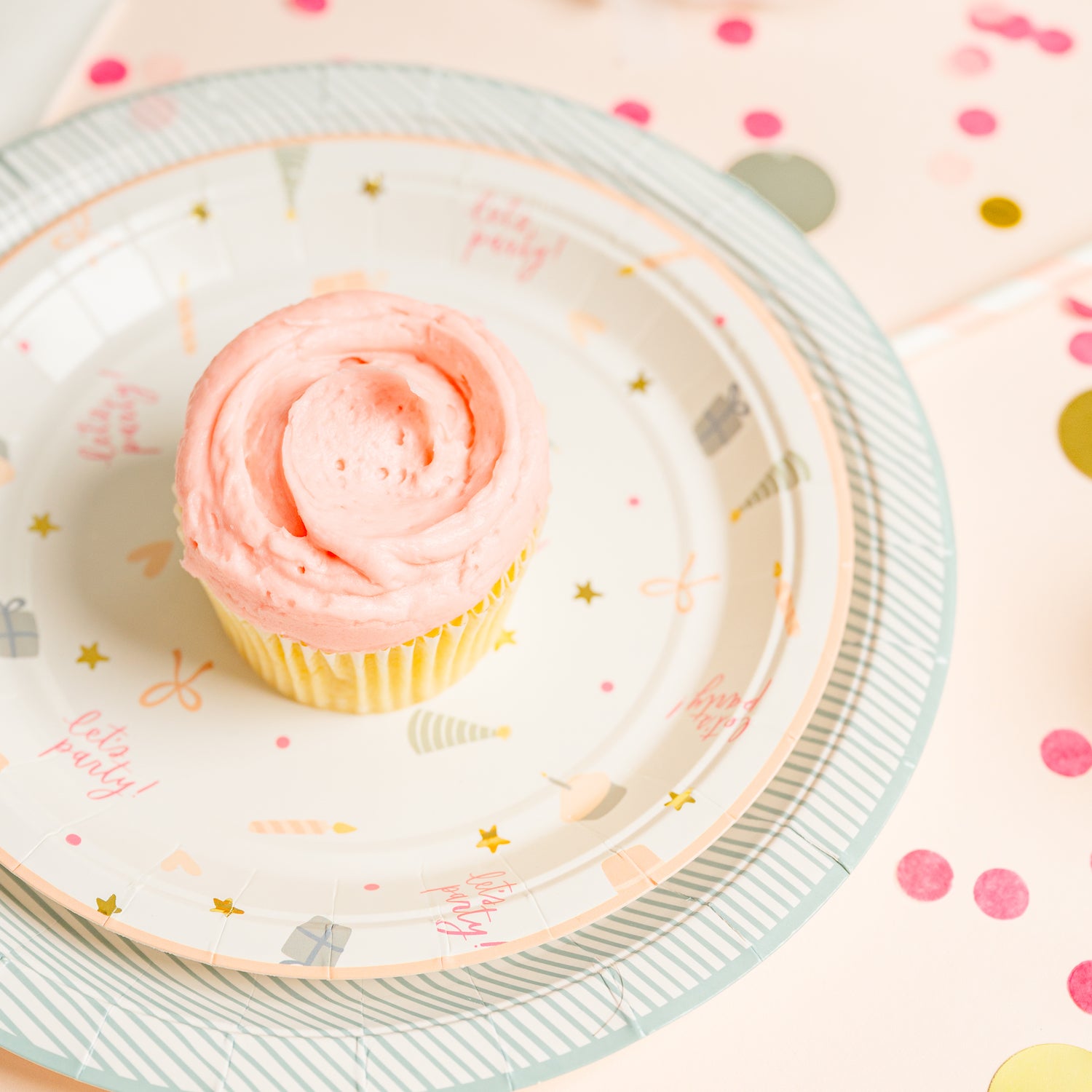 Birthday party supplies with pink cupcake