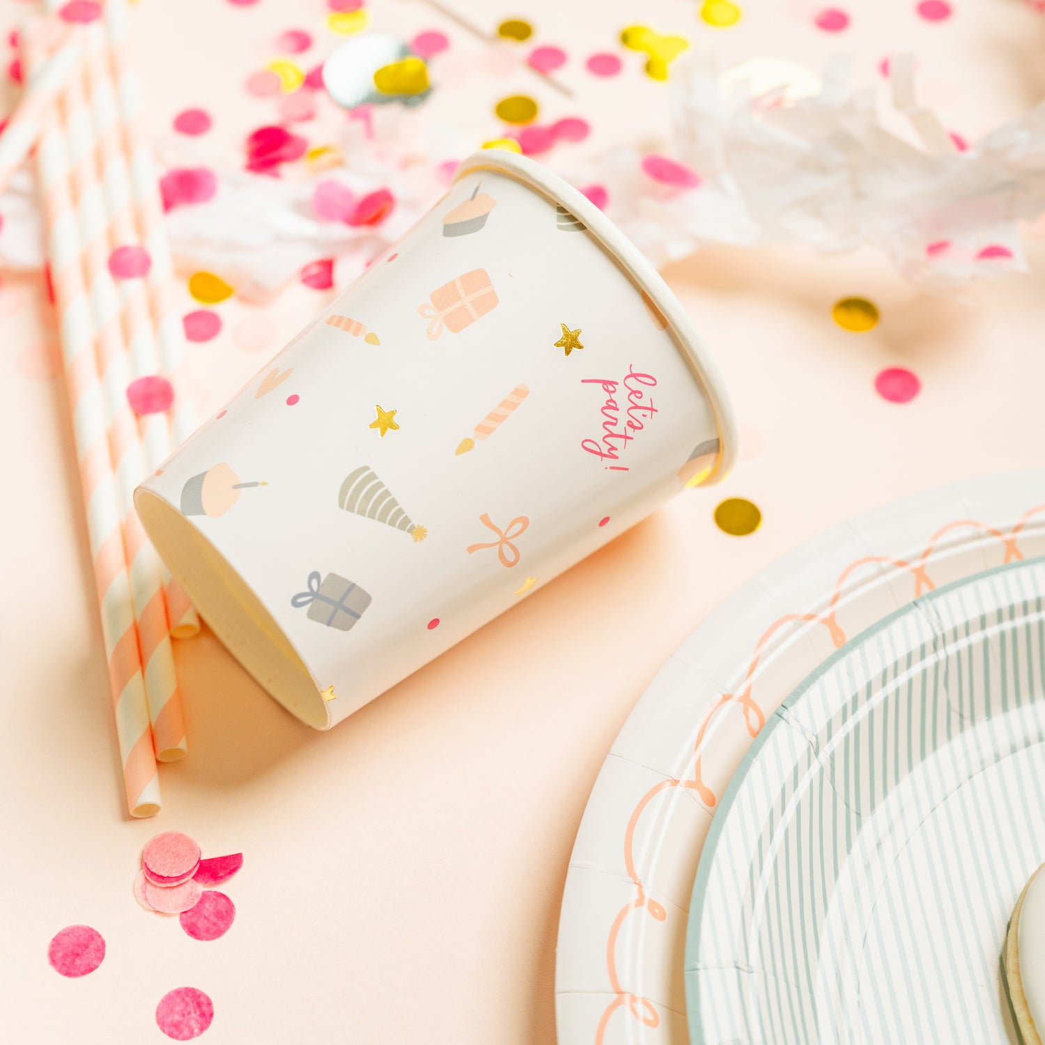 birthday party icon cup with confetti and party paper plates in pink and blue