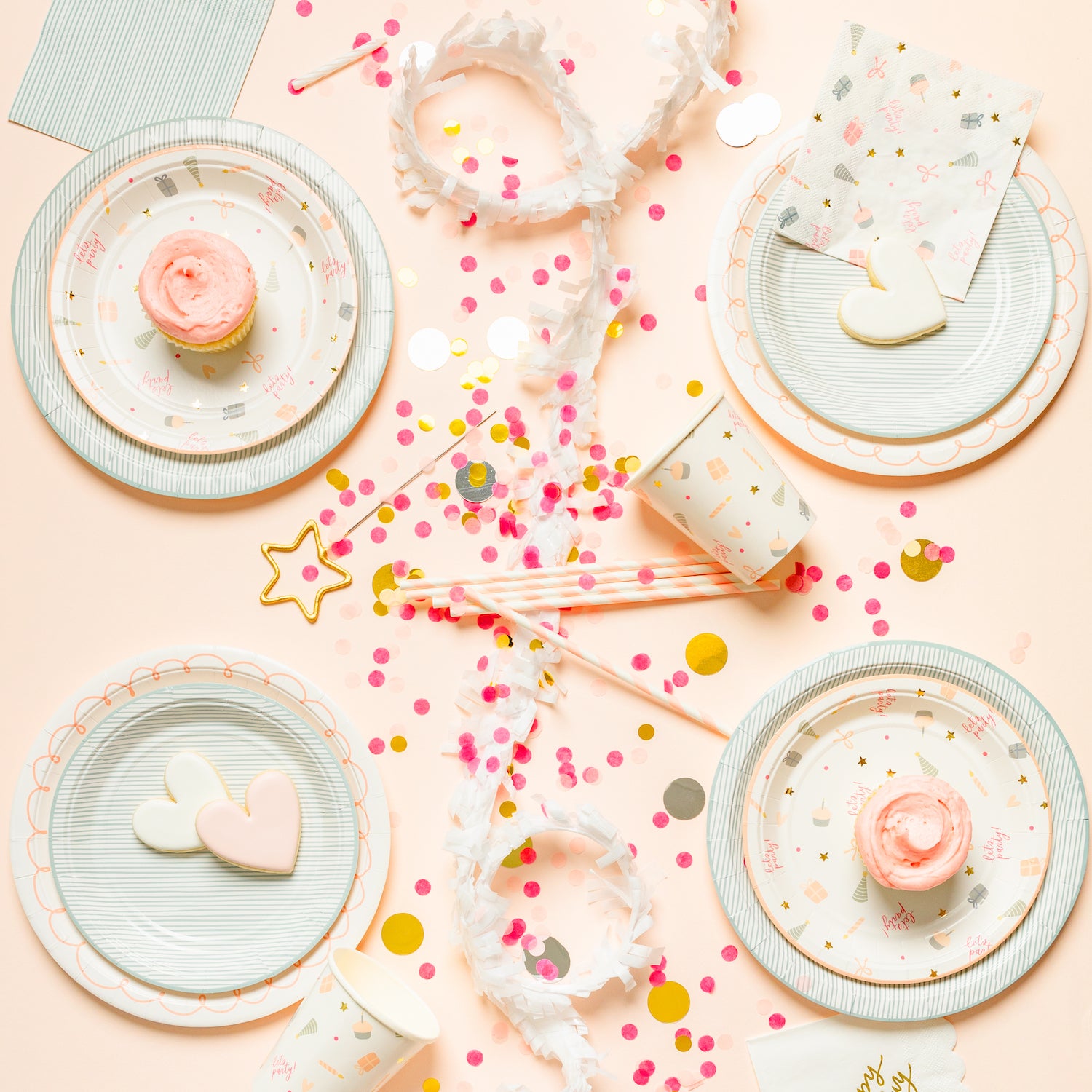 Birthday party tablescape with mixed patterns in blue white pink and gold