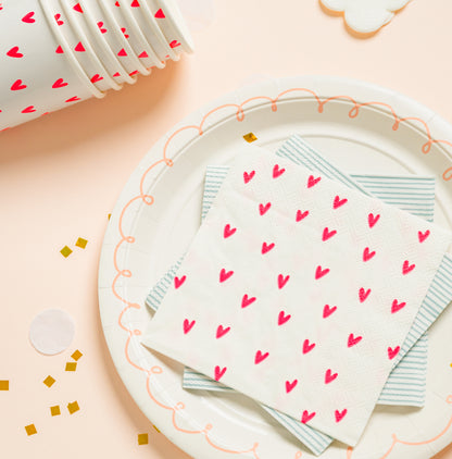neon heart cups and napkin on pink swirl plate