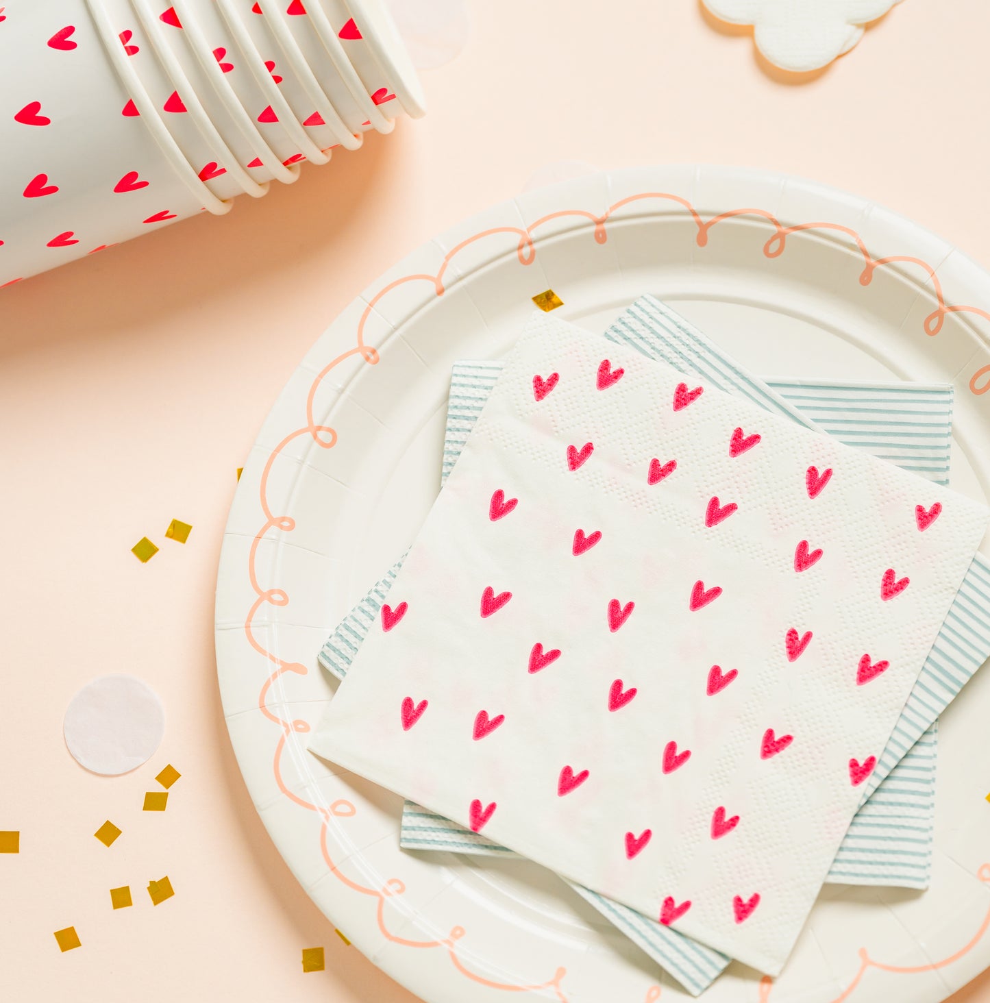 neon pink heart cups and napkin mixed with blue and pink patterns