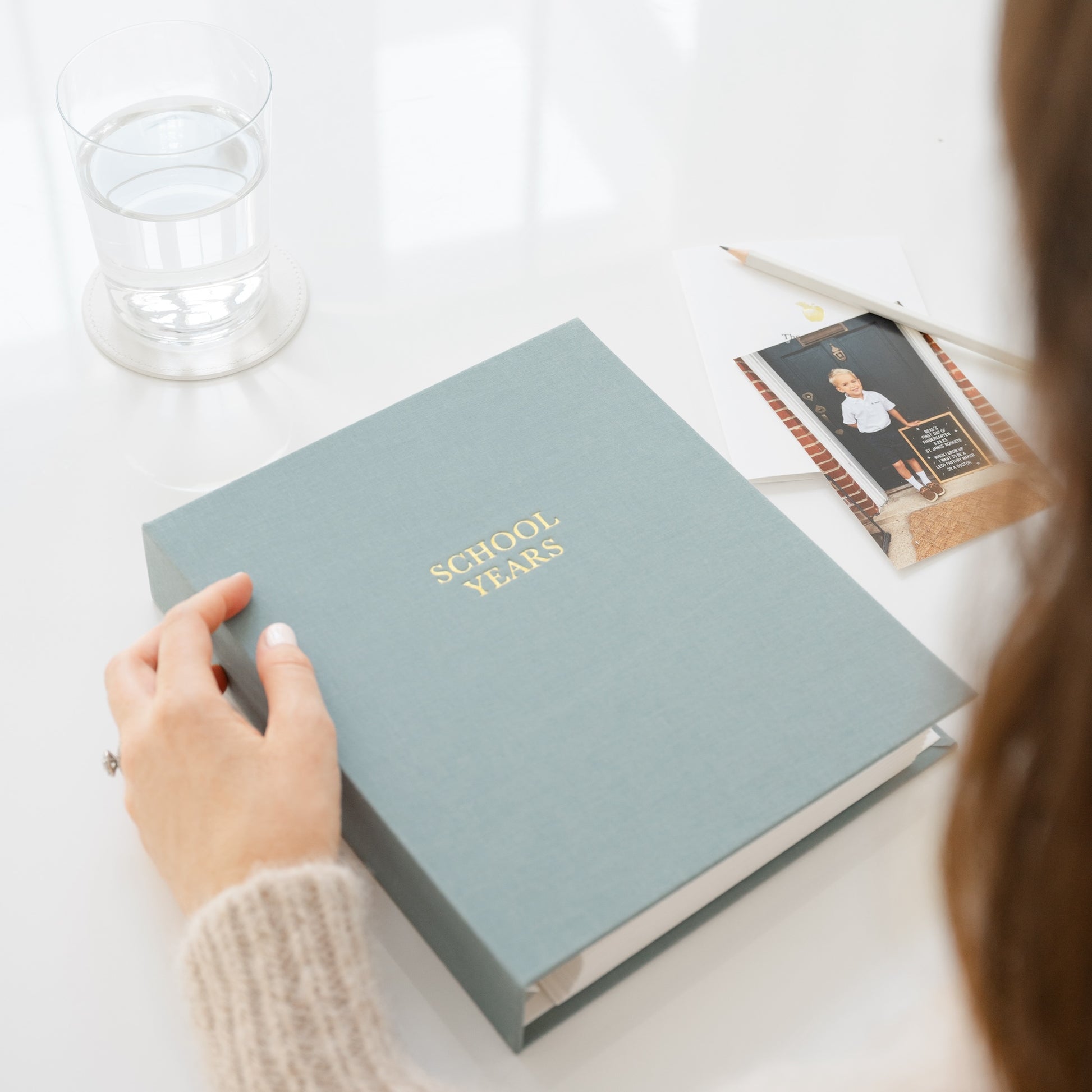 Harbor blue school years book in hand on desk