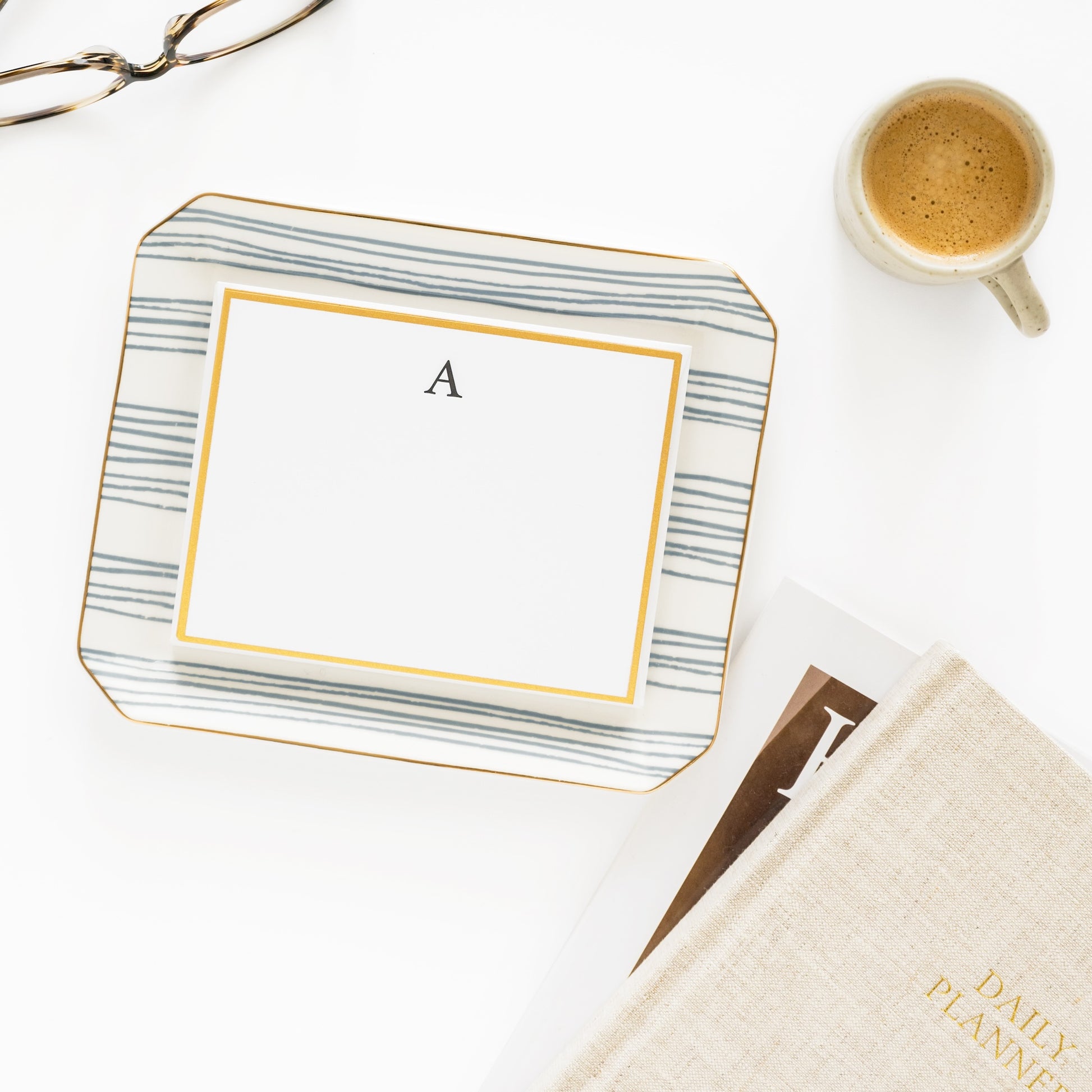 Dusty blue stripe trinket tray on desk with stationery