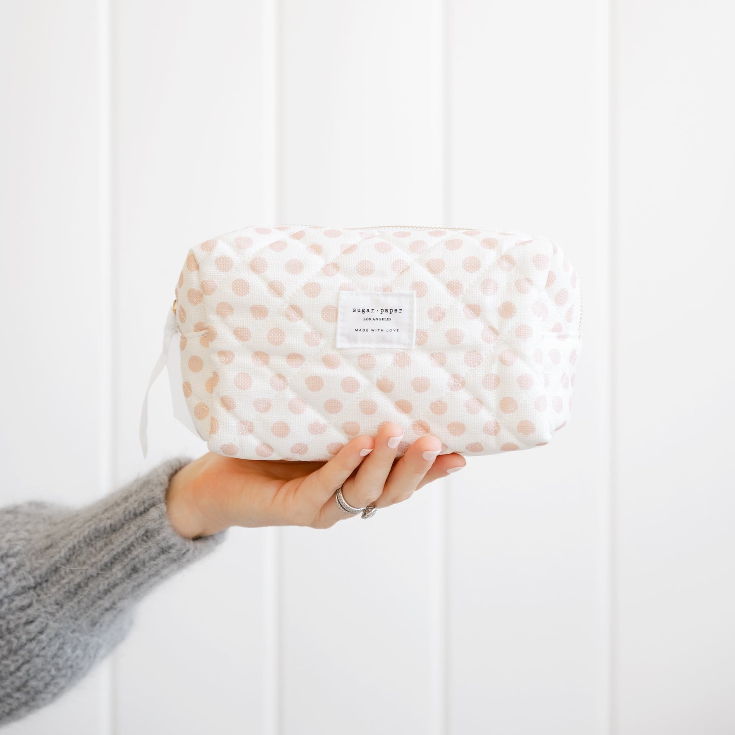 Rose dot cosmetic pouch in hand