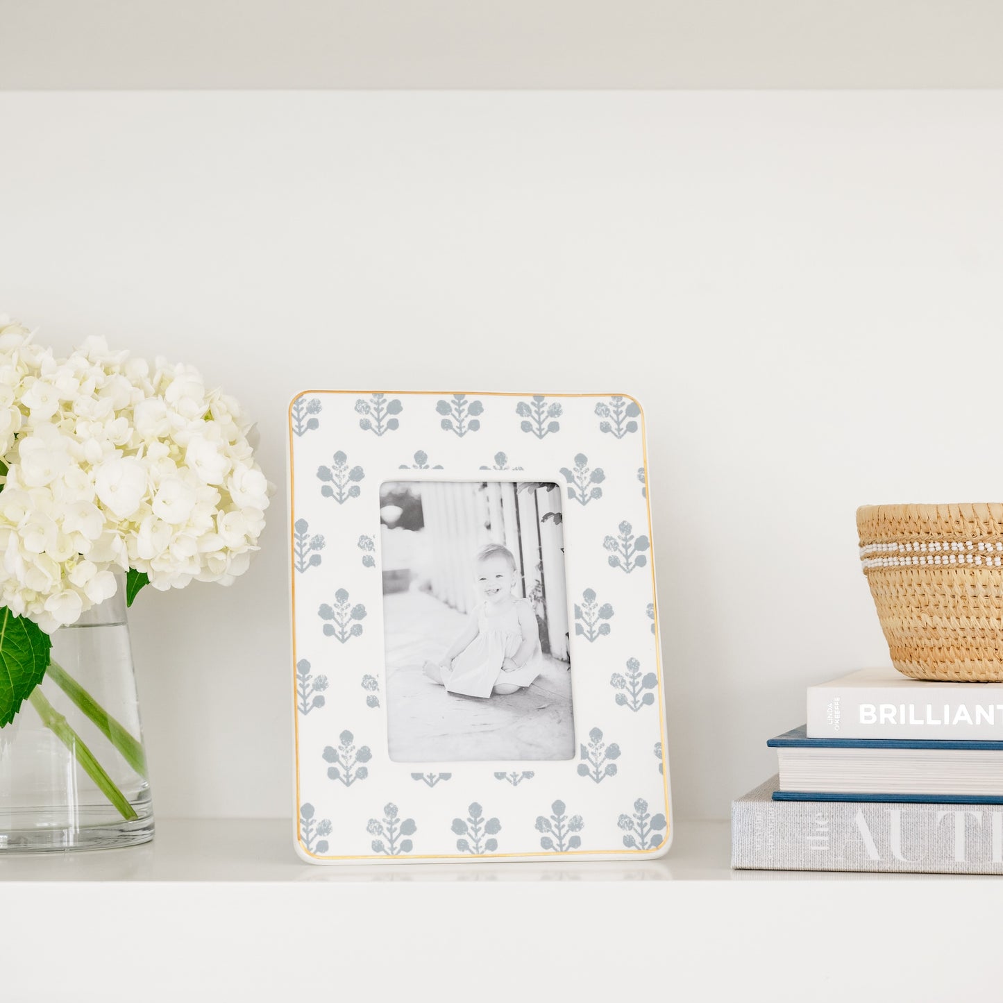 Blue floral picture frame on shelf