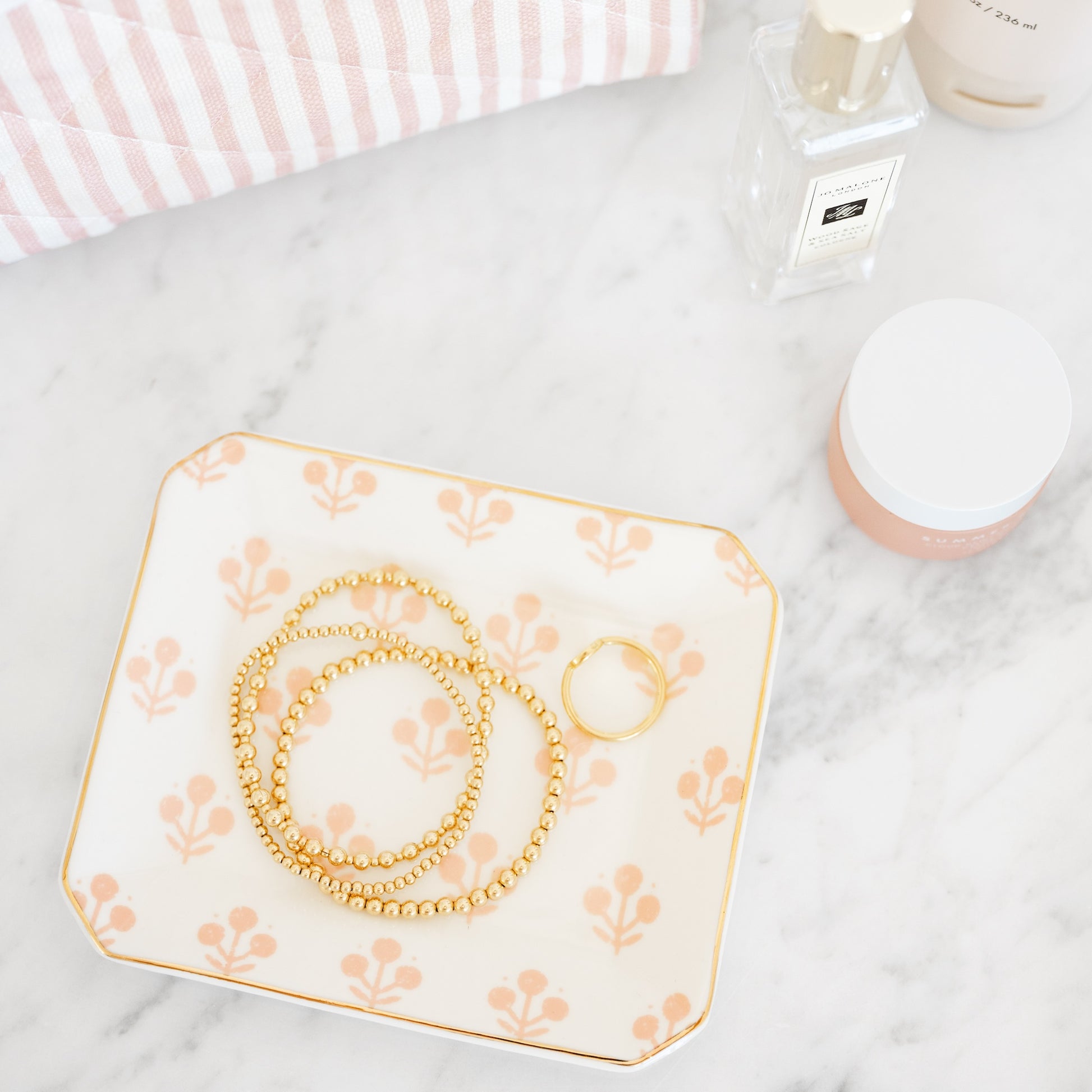 Rose floral tray with bracelets in bathroom