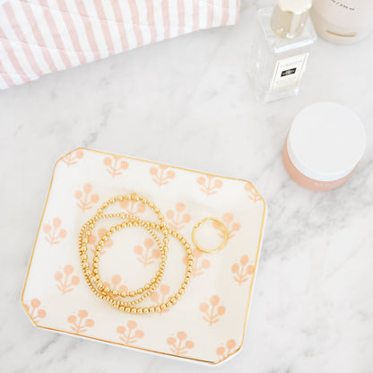 Rose floral tray with bracelets in bathroom