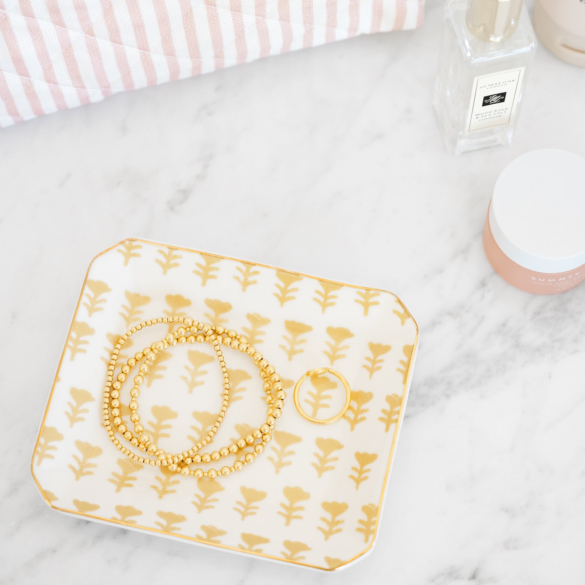 honeycomb yellow floral tray in bathroom with cosmetics