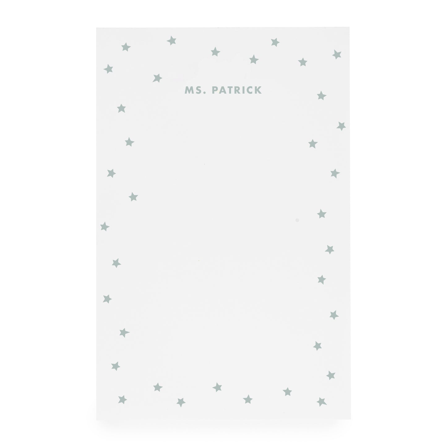 White notepad with scattered star border and 'ms. patrick' text in mint green ink