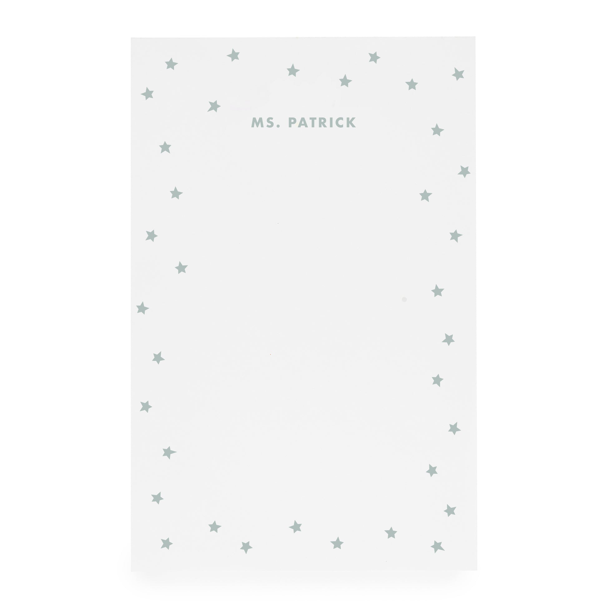 White notepad with scattered star border and 'ms. patrick' text in mint green ink