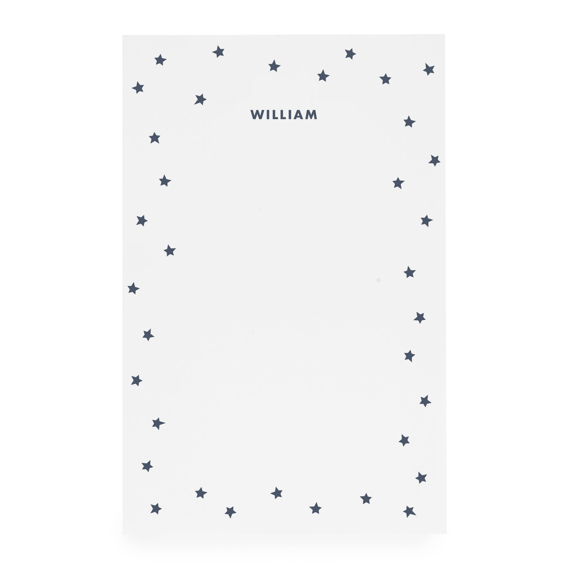 White notepad with scattered star border and 'william' in navy ink