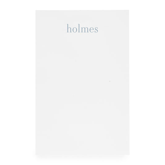 white notepad with blue 'holmes'
