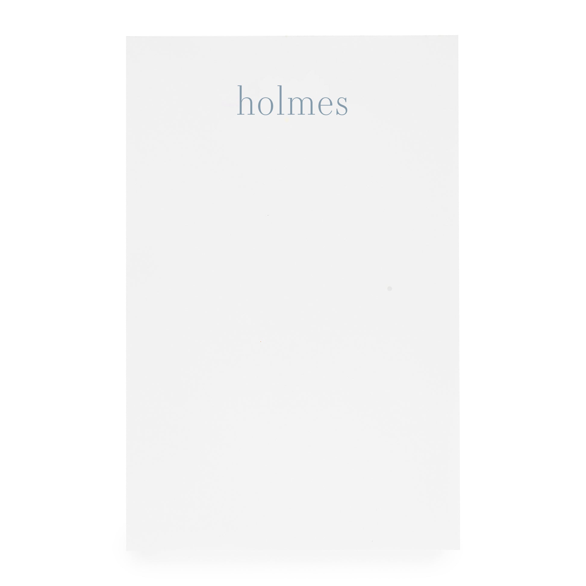 white notepad with 'holmes' text in blue ink