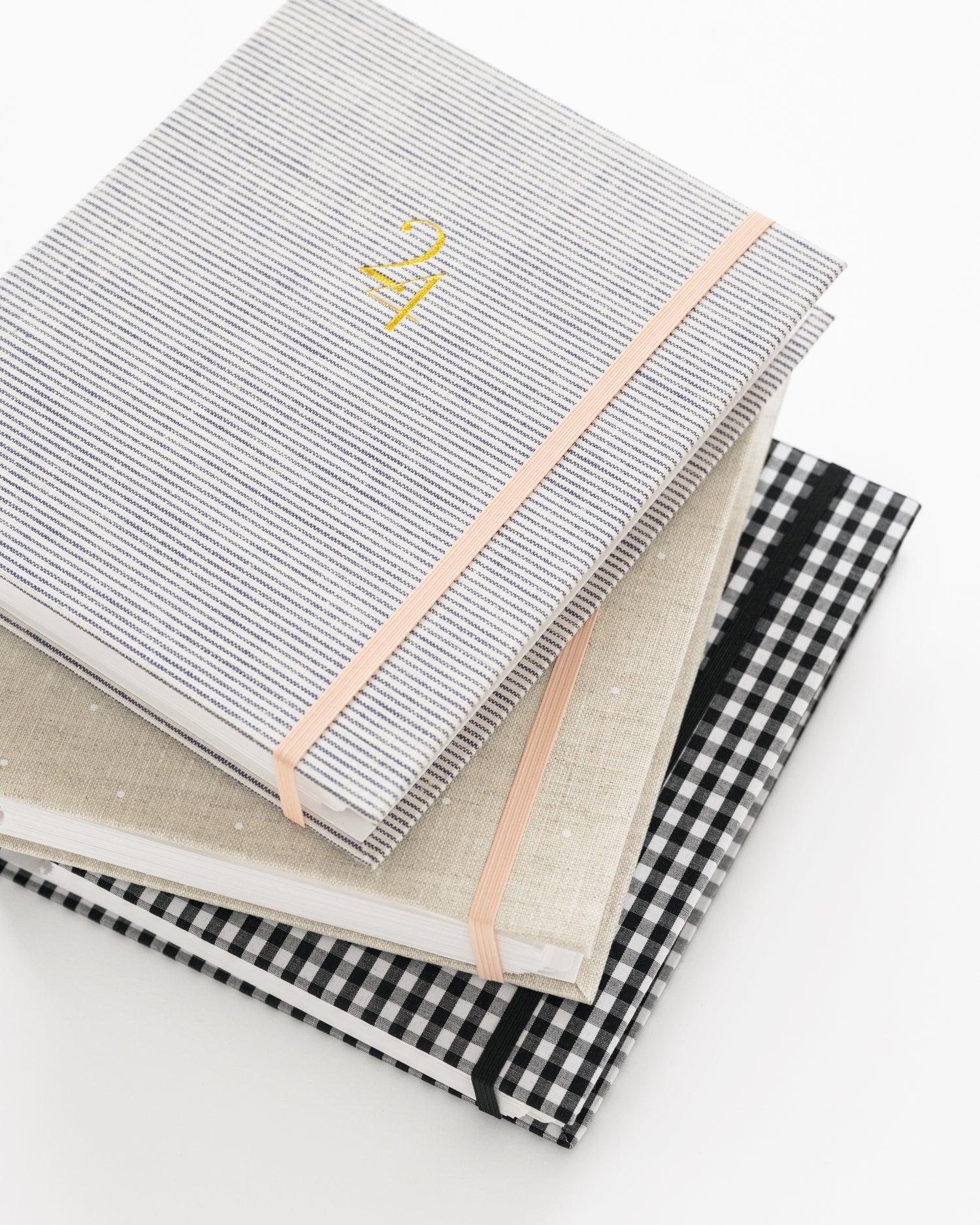 Stack of concealed planners with different fabrics