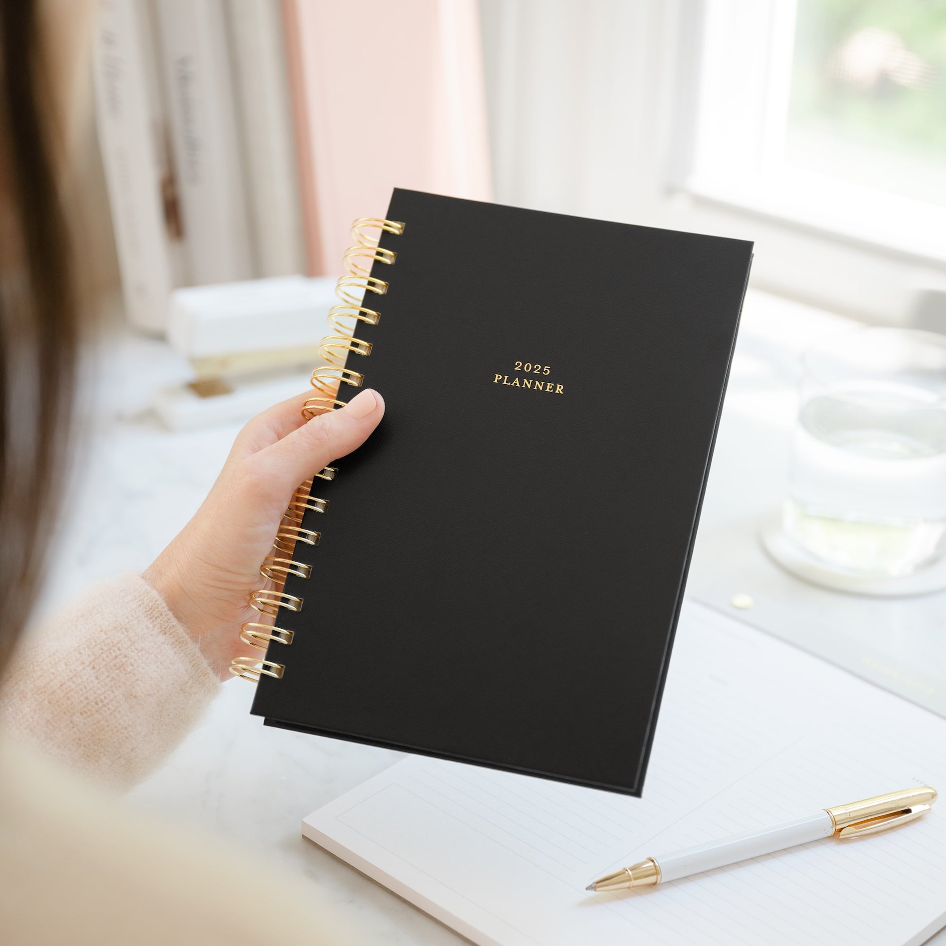 Small black spiral planner in ahnds