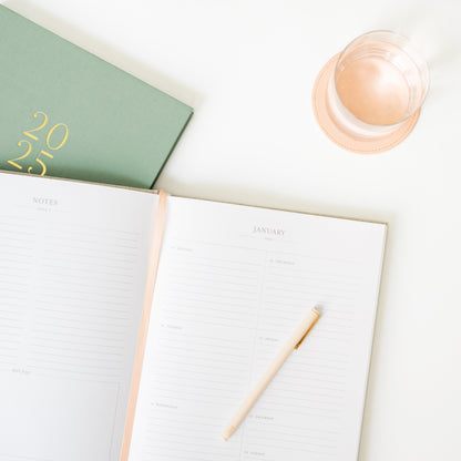 Open weekly page of desk agenda showing the sage green fabric cover