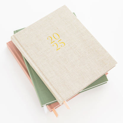 Stack of all desk agendas in flax, rose, and sage green