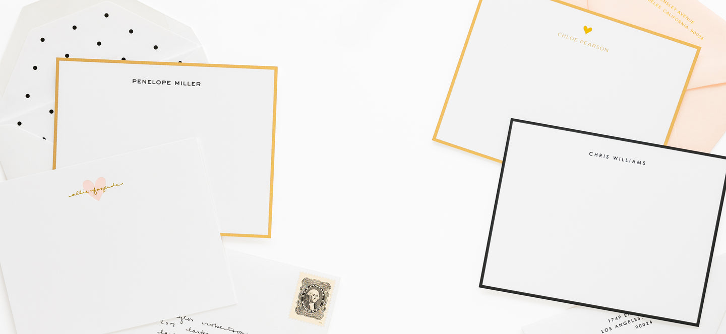 Assorted custom stationery designs in black, gold, and white