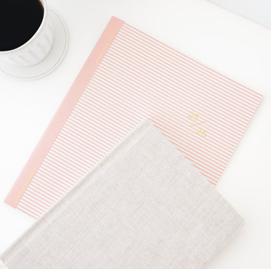 rose stripe 25-26 planner and flax tailored journal with cup of coffee