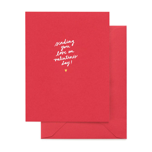 Red greeting card with "sending you love on valentine's day" in white foil with a gold heart paired with a red envelope