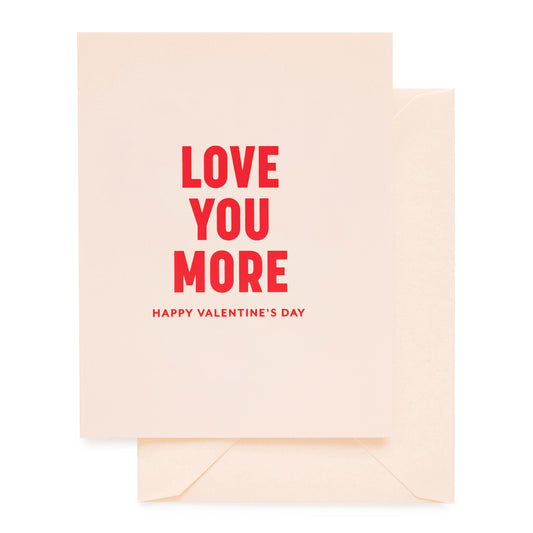 Pale pink Valentine's Day card with 'Love You More Happy Valentine's Day' printed in red foil