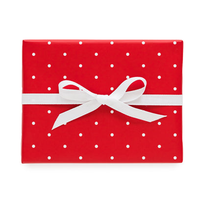 Red with white polka dot wrapped gift with a white ribbon