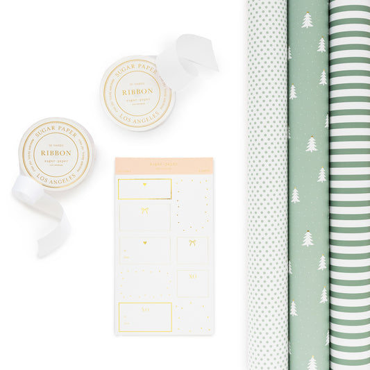 Green and white holiday wrapping kit with wrapping paper rolls, stickers and white ribbon spools