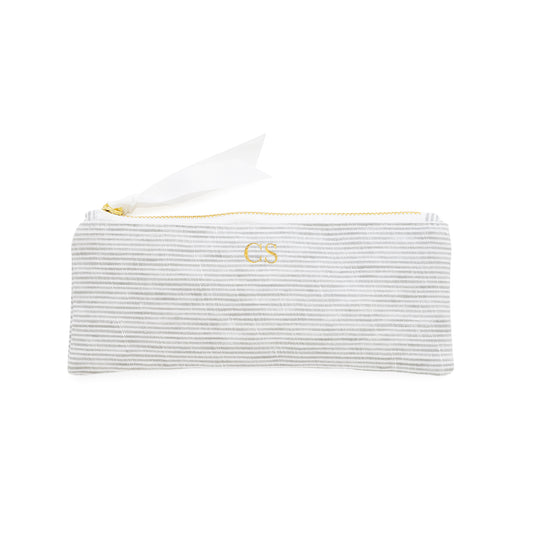 Striped pencil pouch with a gold zipper, white ribbon pull, and gold foil initials
