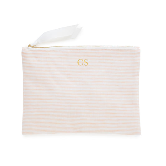 Pink striped pouch with gold initials, gold zipper, and white ribbon pull