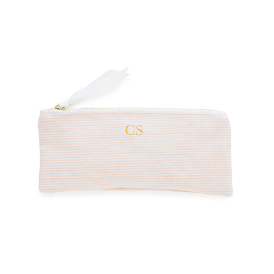 Pink striped pouch with gold initials, gold zipper, and white ribbon pull