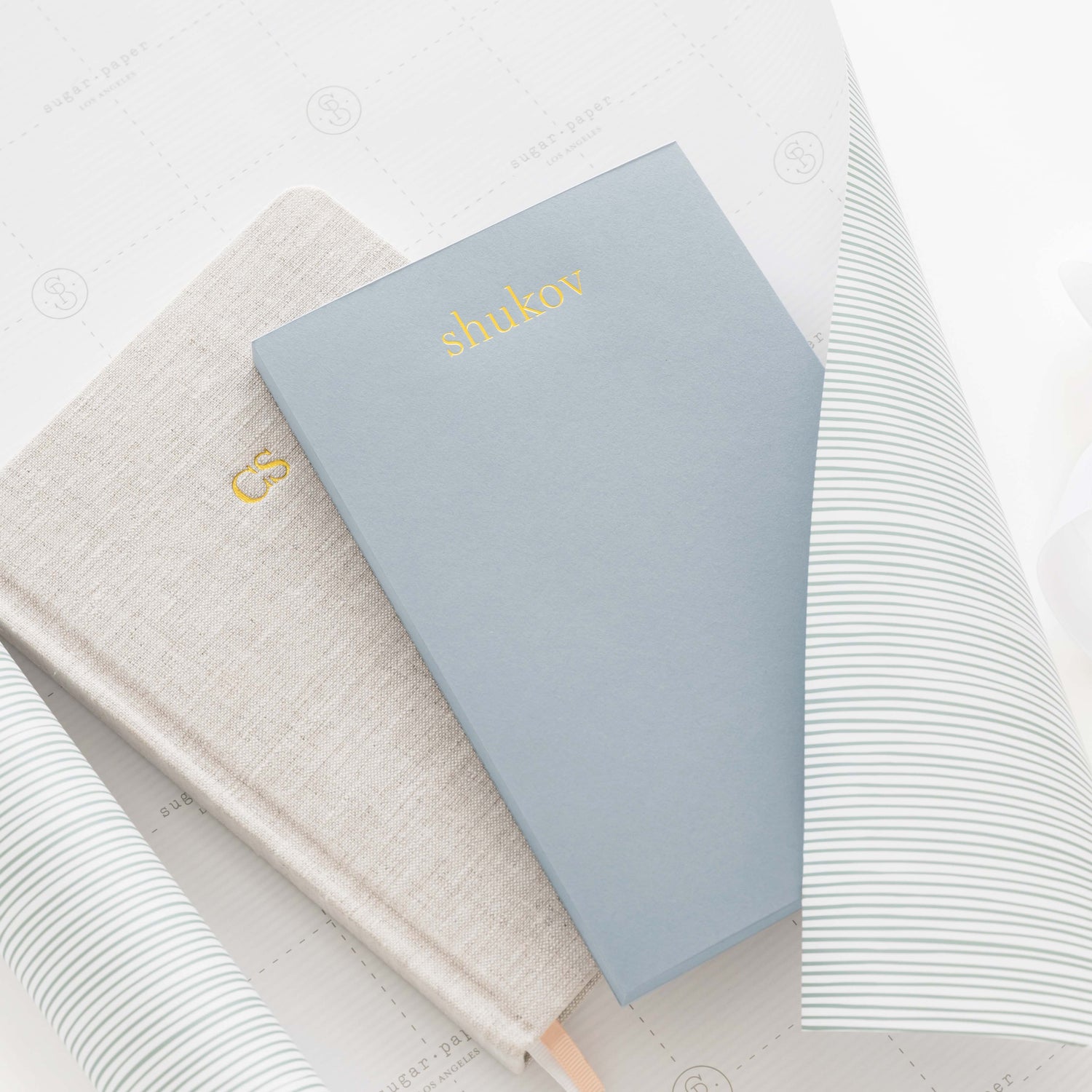 A journal and a notepad on gift wrap.