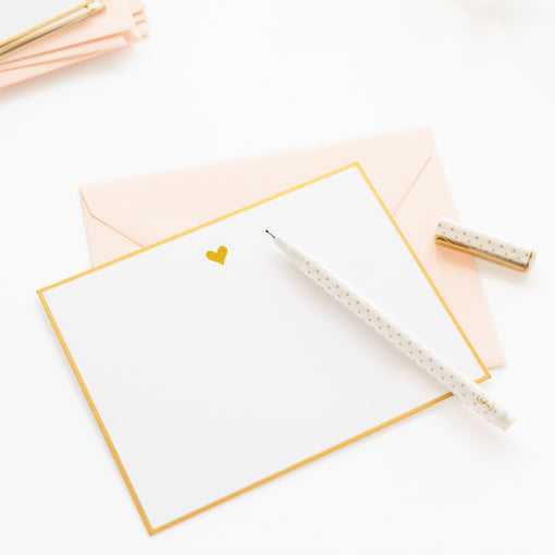 white notecard with gold heart and bordering and pink envelope