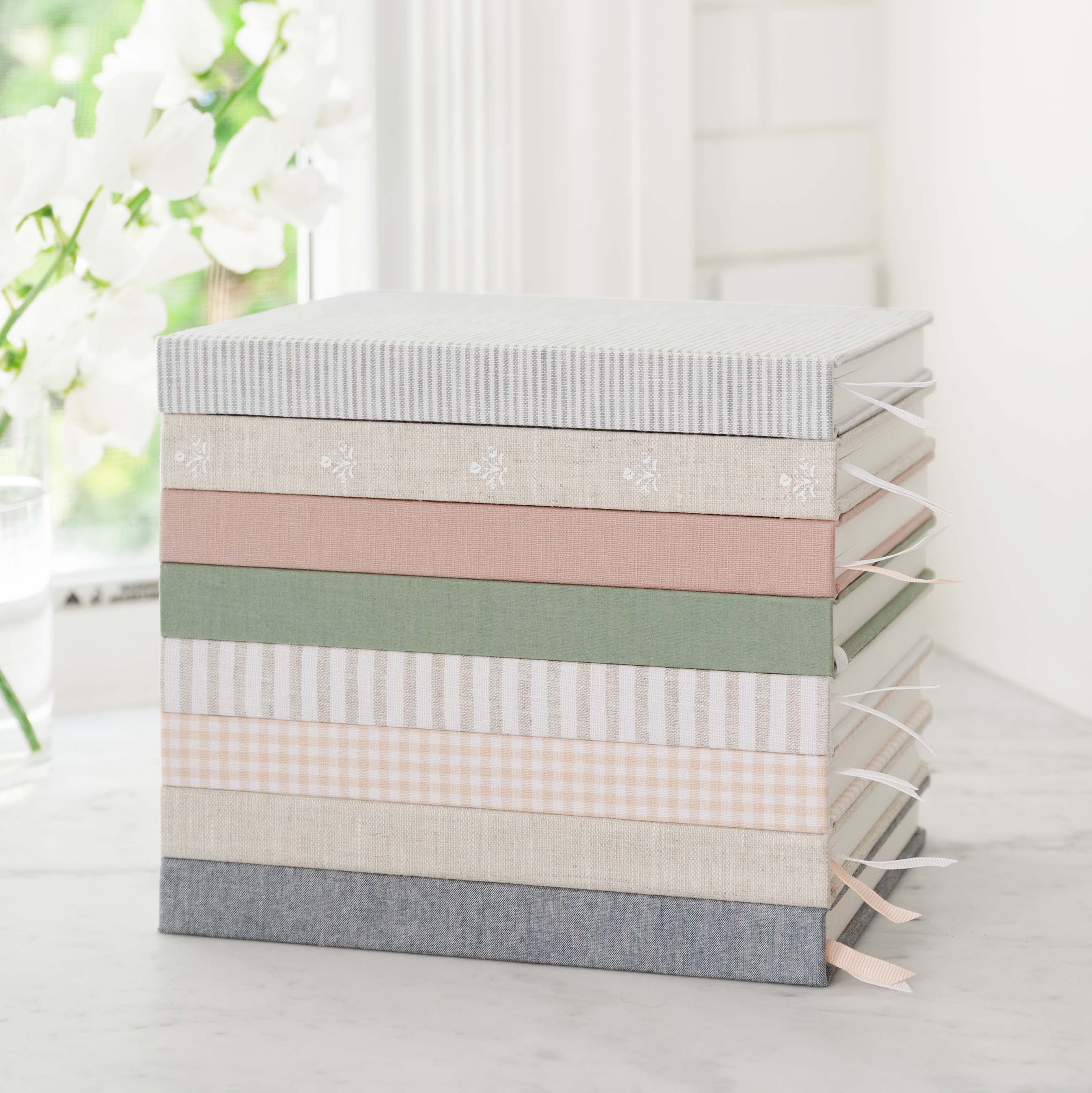 Stack of fabric-bound journals with ribbon markers