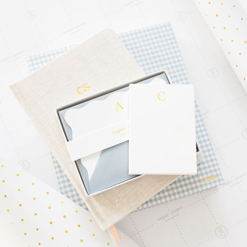 Stack of note set, notebook, journal, and baby book.