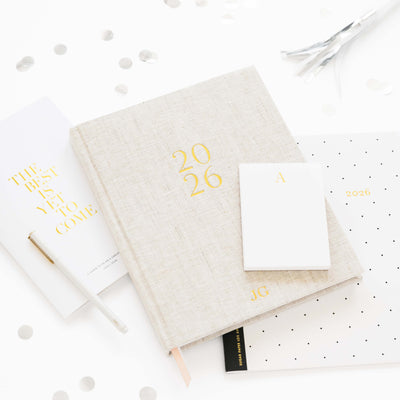 Flax planner with gold text on a white background