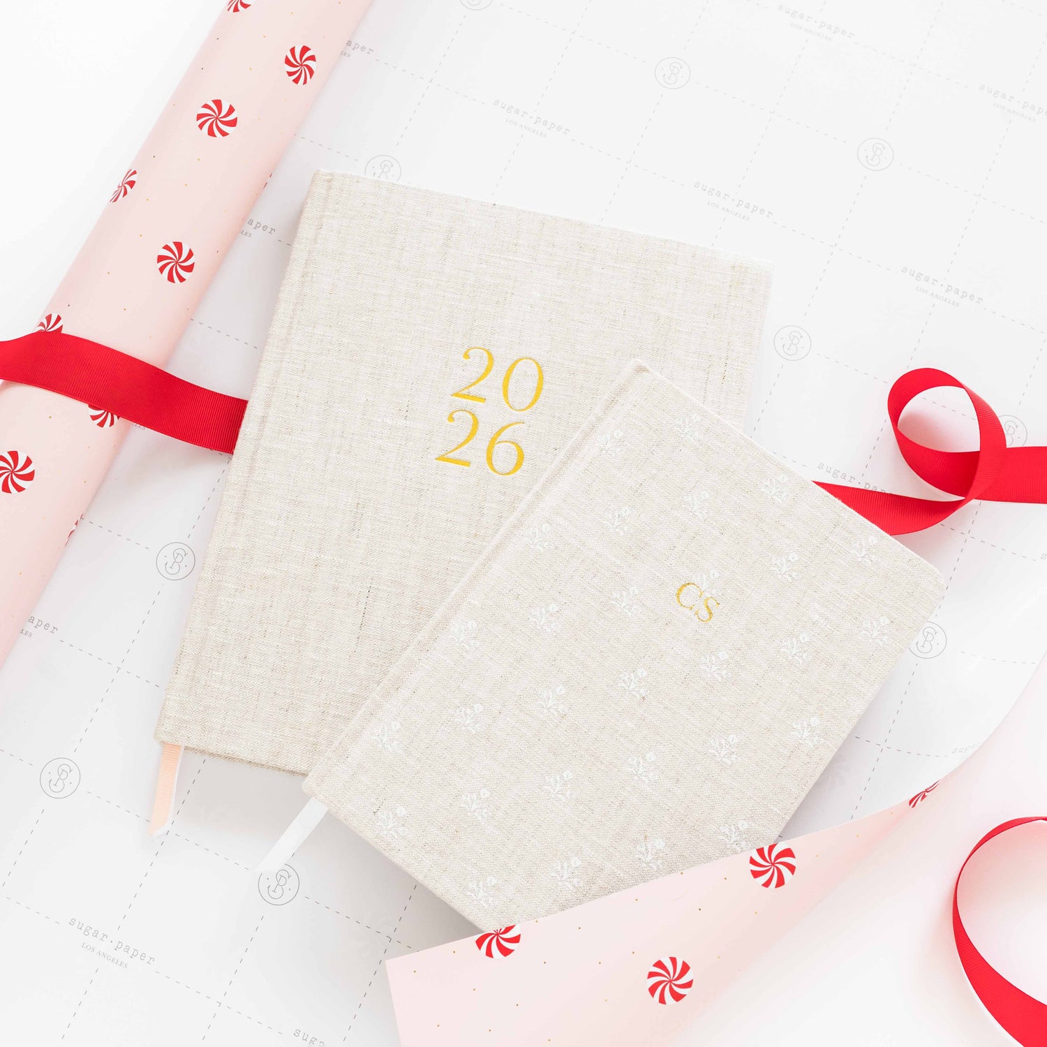 flax planner and journal on pink peppermint patterned gift wrap