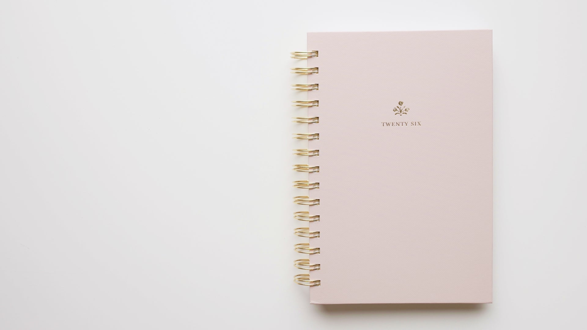 Load video: Interior of 2026 small pink spiral planner with gold spiral