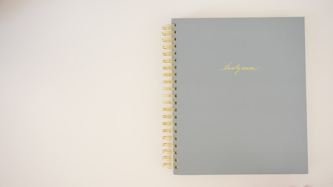 Person flipping through 2027 Blue Large Weekly Planner interior