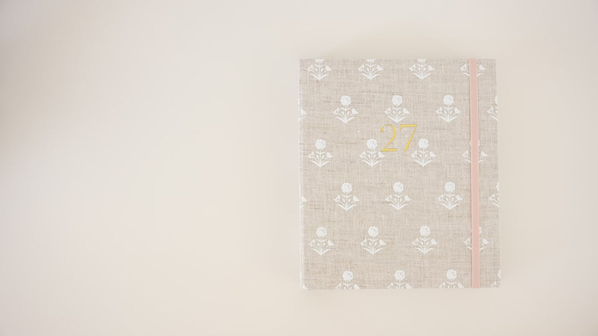 Load video: Video of someone opening the 2027 concealed flax floral agenda and showing the interior pages