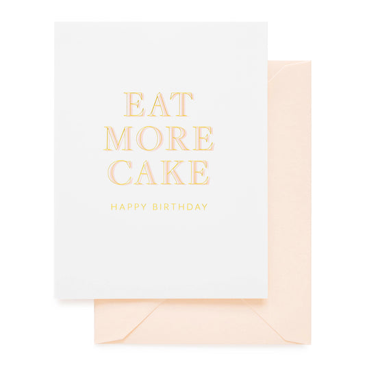 White birthday card printed in pink and gold foil with eat more cake happy birthday